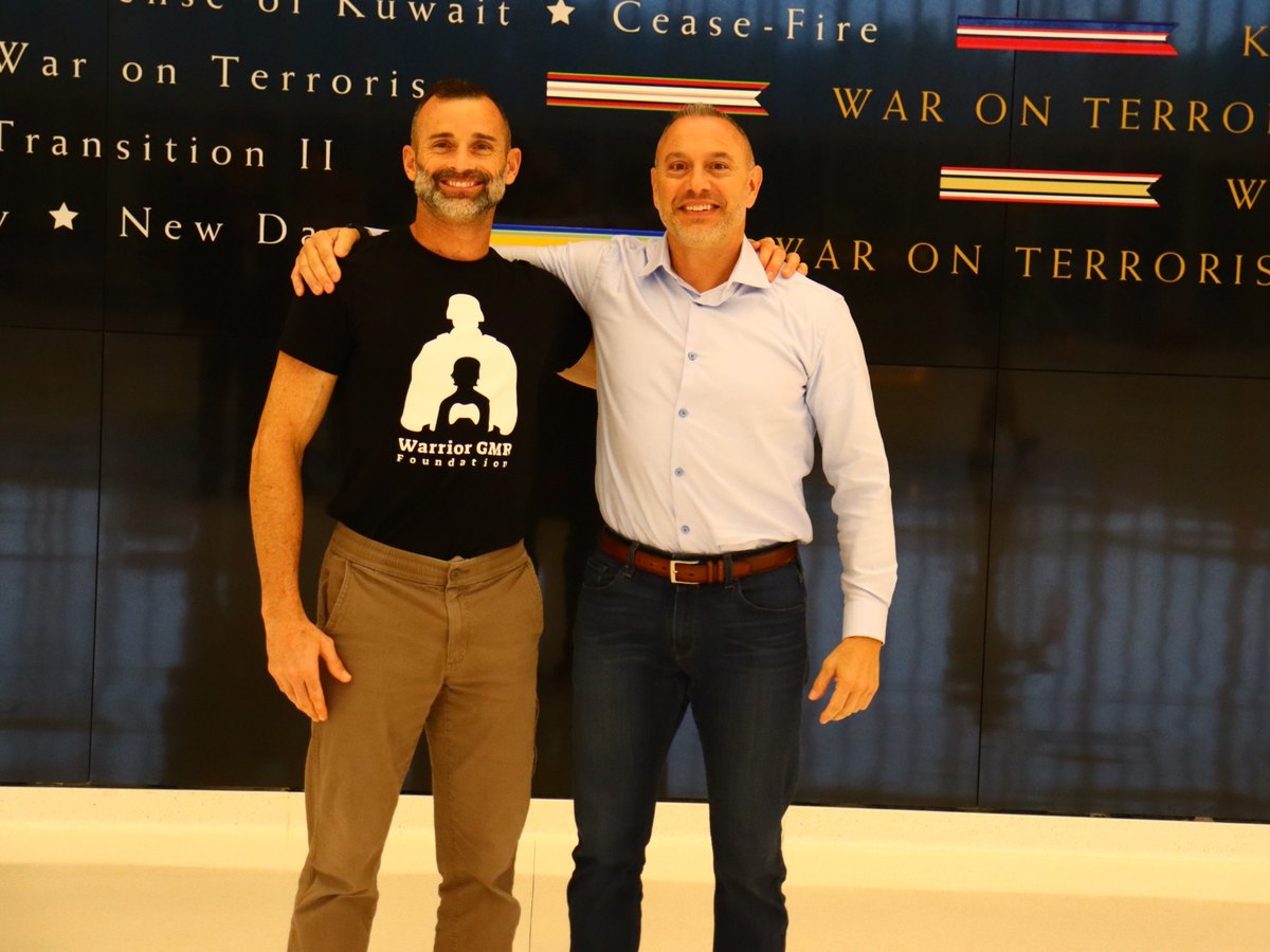 Ken Corigliano in a Warrior GMR Foundation shirt at a military memorial wall